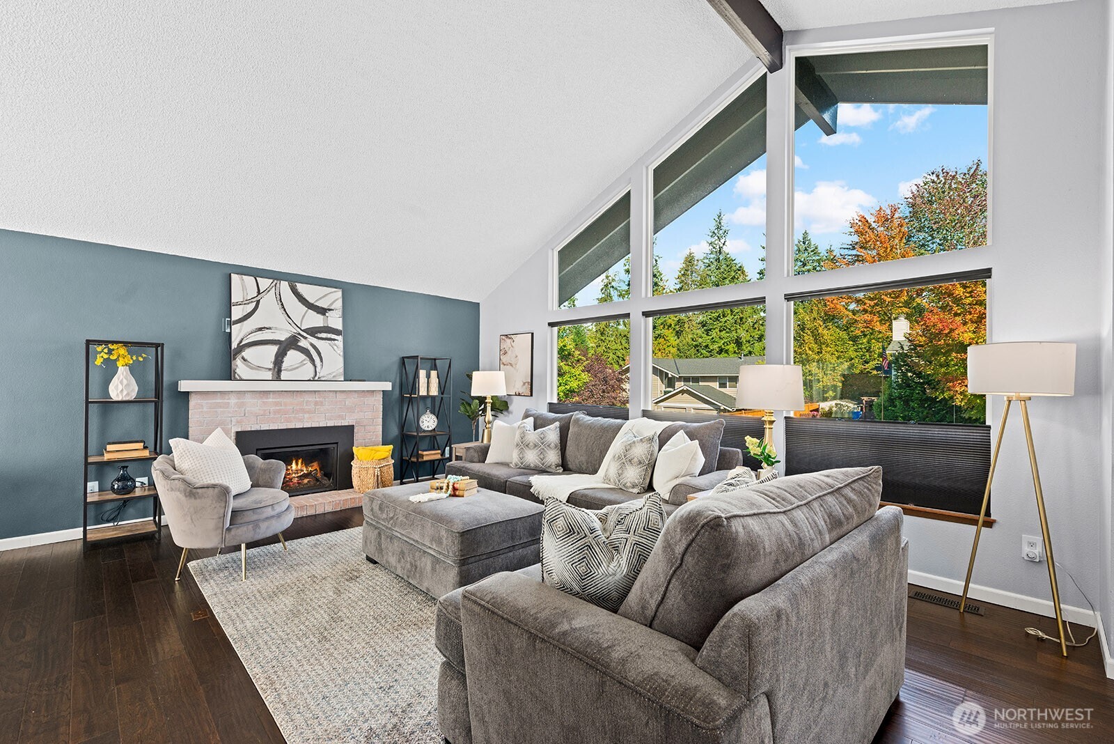 2604 177th Street Southeast Bothell, WA 98012 - Photo 2 of 35 a living room with furniture a fireplace and a floor to ceiling window
