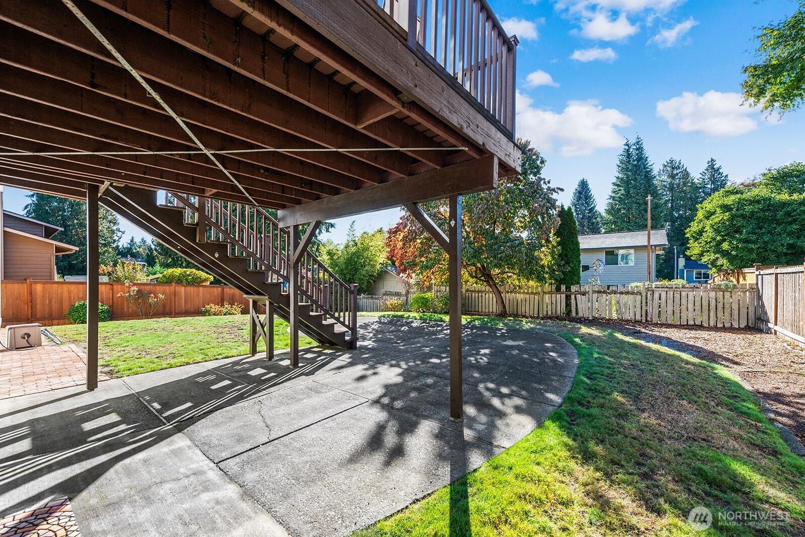 2604 177th Street Southeast Bothell, WA 98012 - Photo 29 of 35 a view of a backyard with table and chairs under an umbrella with a small yard