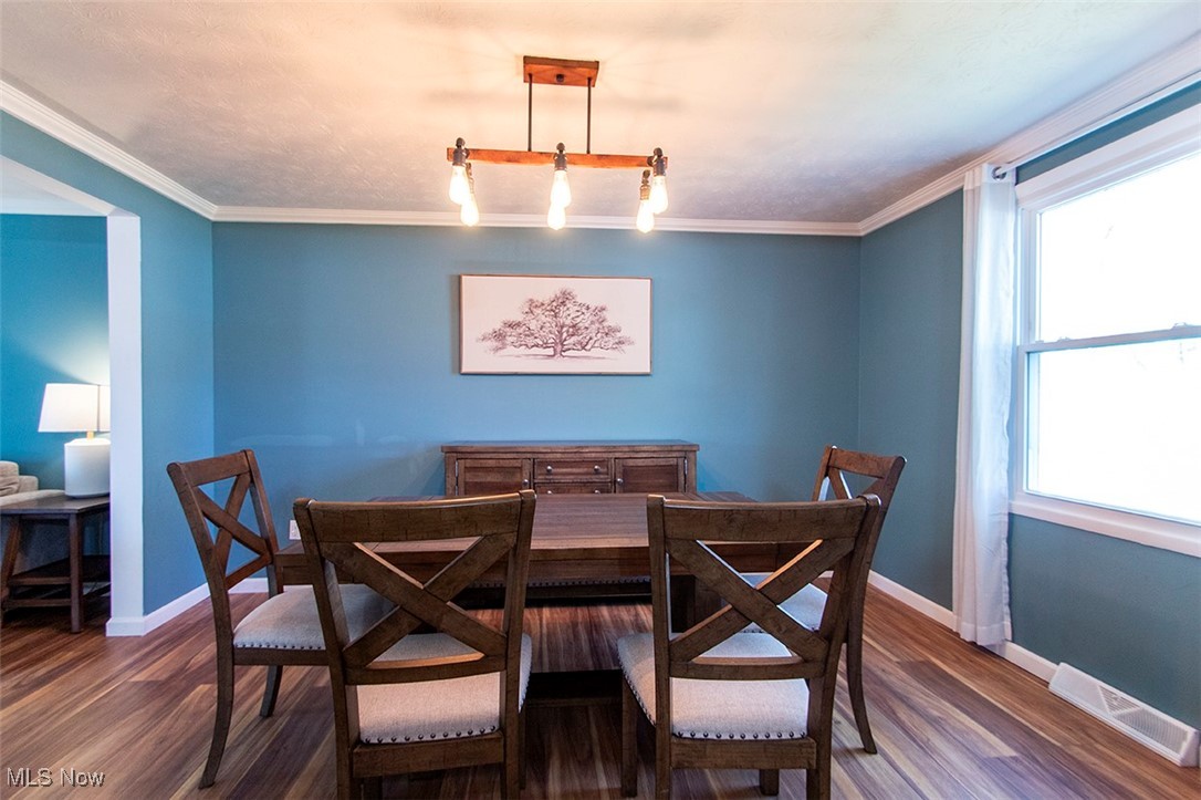 2449 Audubon Road Akron, OH 44320 - Photo 10 of 33 Dining room featuring a wealth of natural light, visible vents, wood finished floors, and baseboards