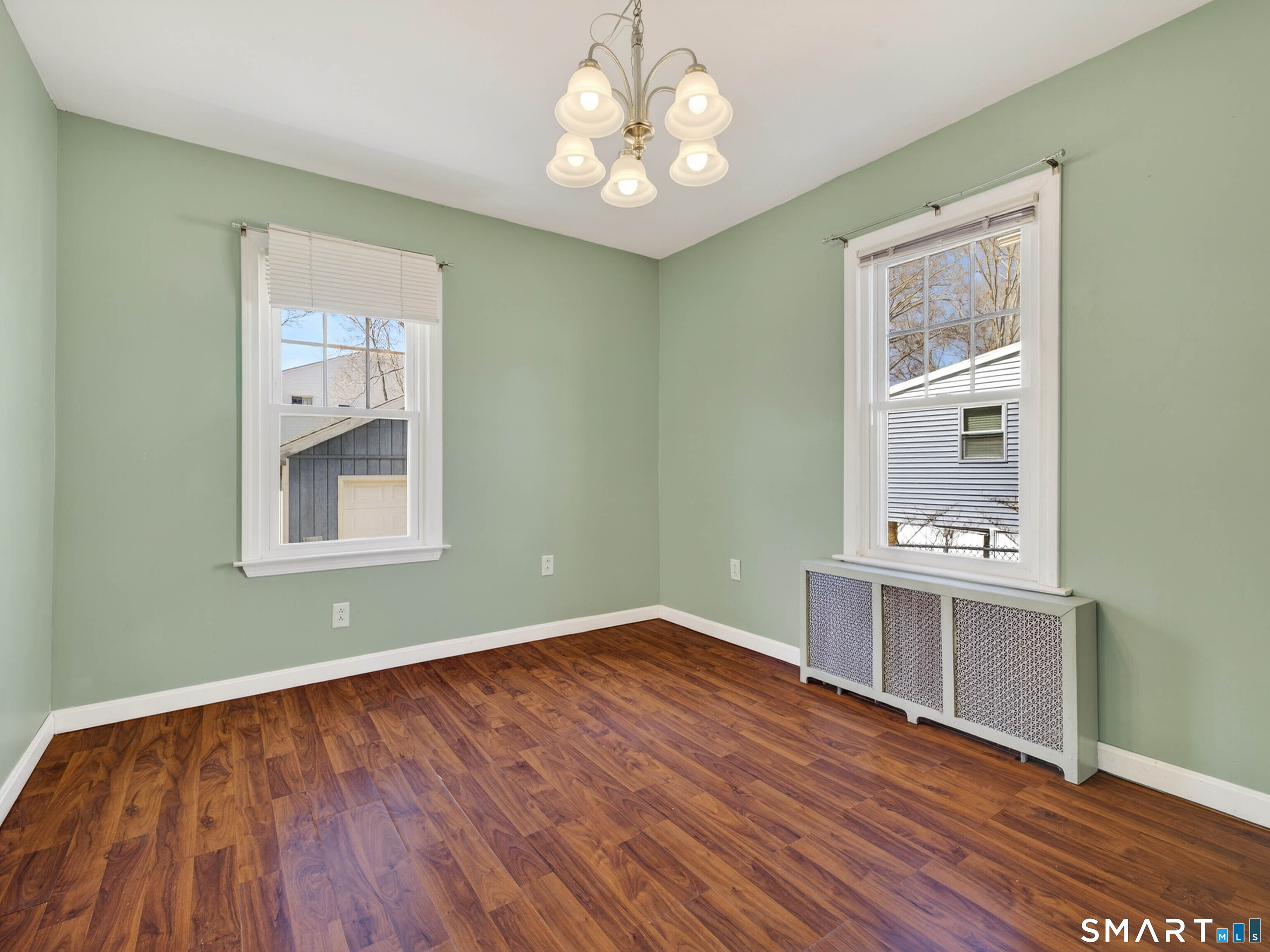 82 North Street Norwich, CT 06360 - Photo 11 of 38 a view of an empty room with window and wooden floor