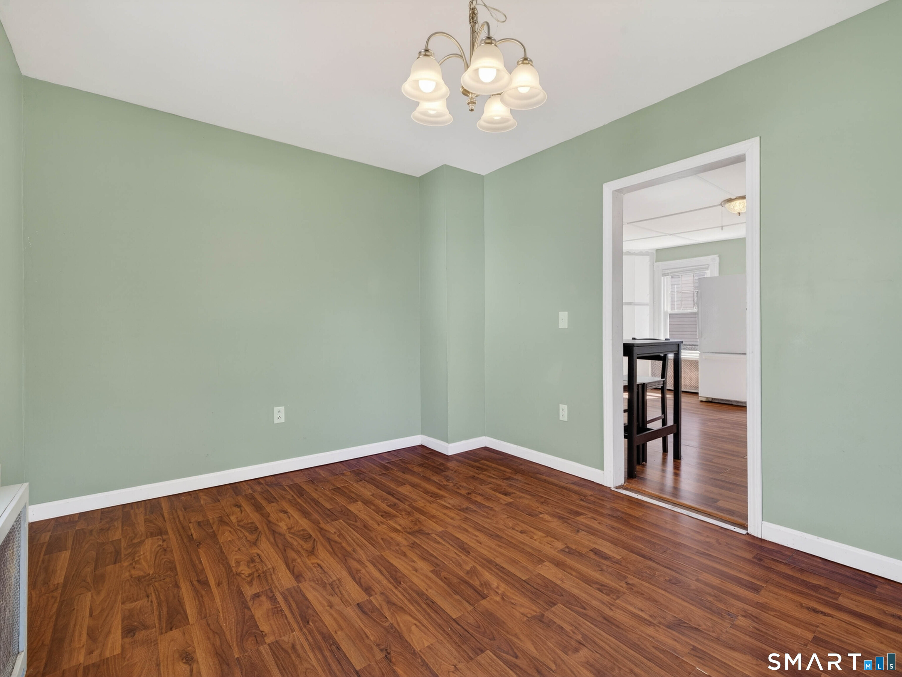 82 North Street Norwich, CT 06360 - Photo 12 of 38 wooden floor in an empty room with a window