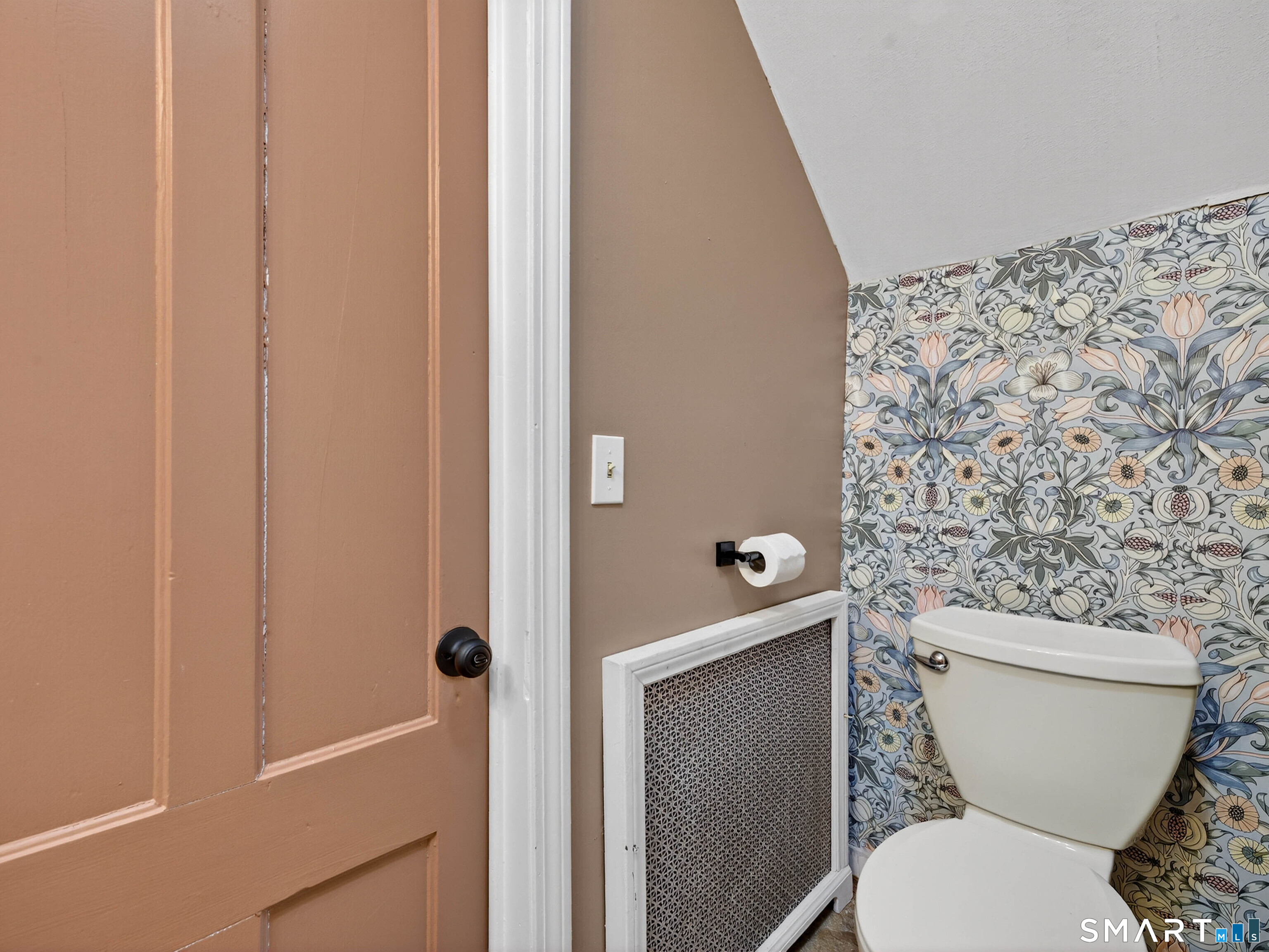 82 North Street Norwich, CT 06360 - Photo 16 of 38 a white toilet sitting next to a shower curtain