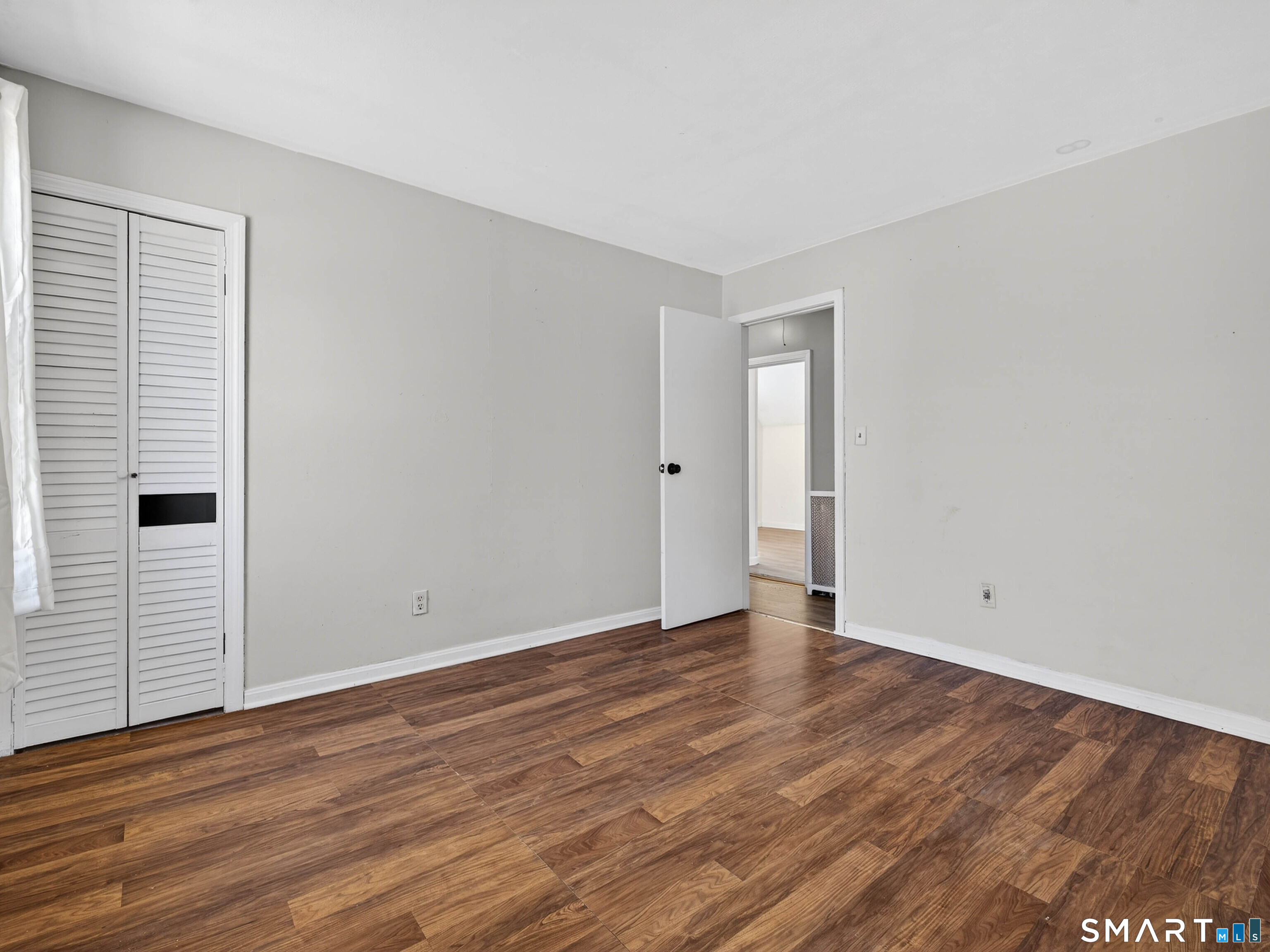 82 North Street Norwich, CT 06360 - Photo 17 of 38 a view of an empty room with wooden floor and a window