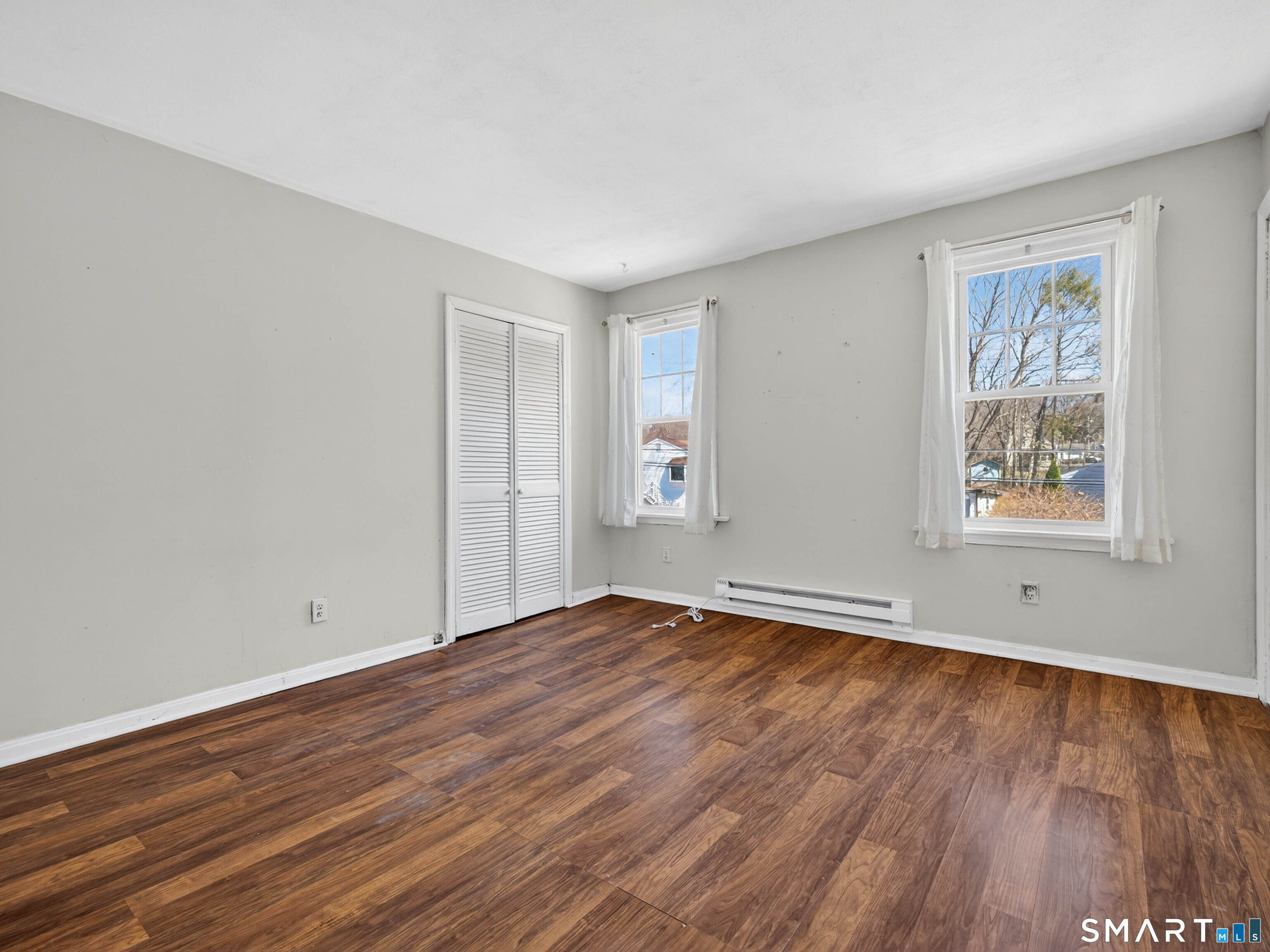 82 North Street Norwich, CT 06360 - Photo 18 of 38 a view of empty room with wooden floor and fan