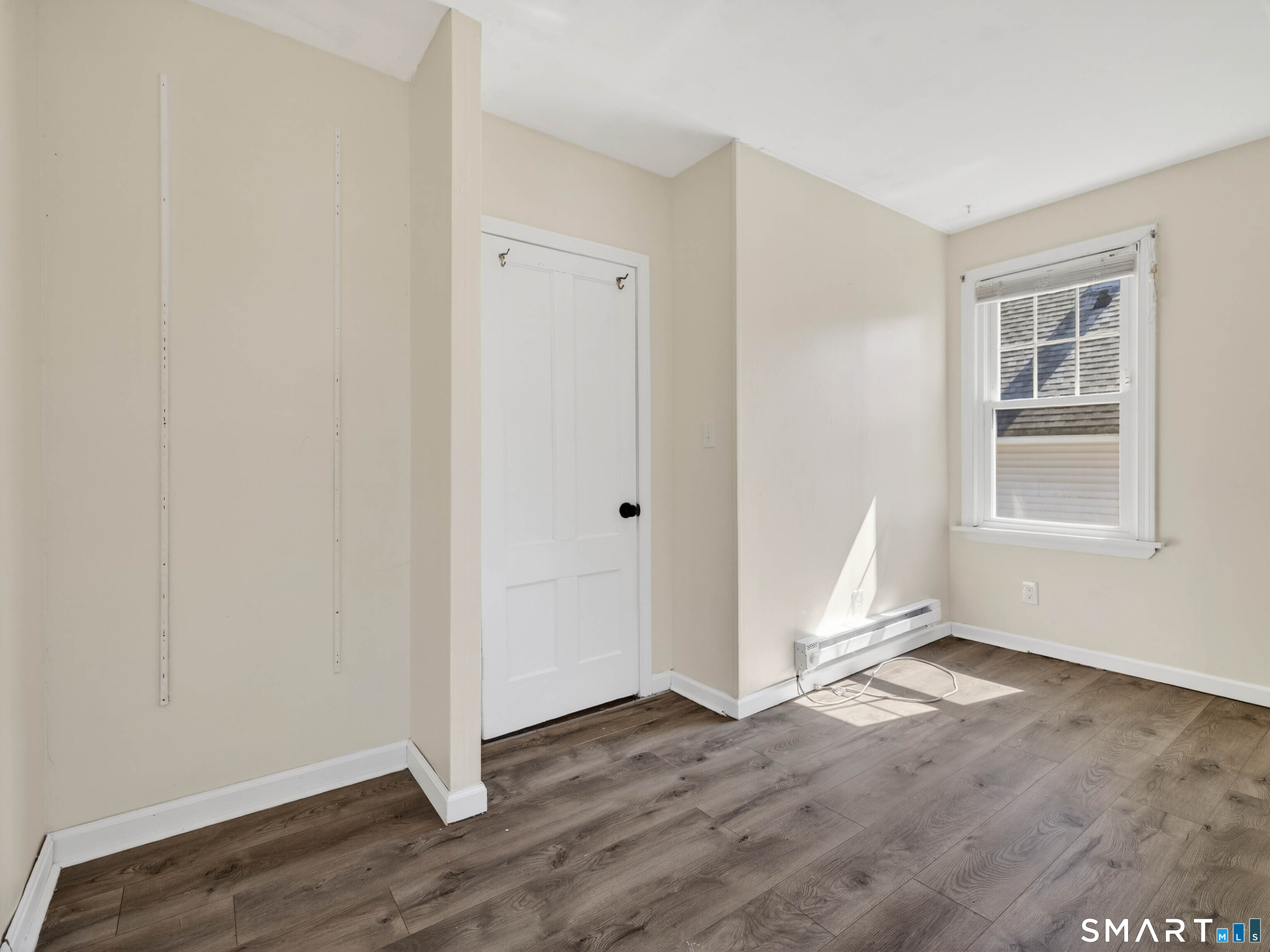 82 North Street Norwich, CT 06360 - Photo 19 of 38 an empty room with wooden floor cabinet and windows