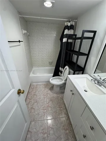 a bathroom with a double vanity sink and a tub