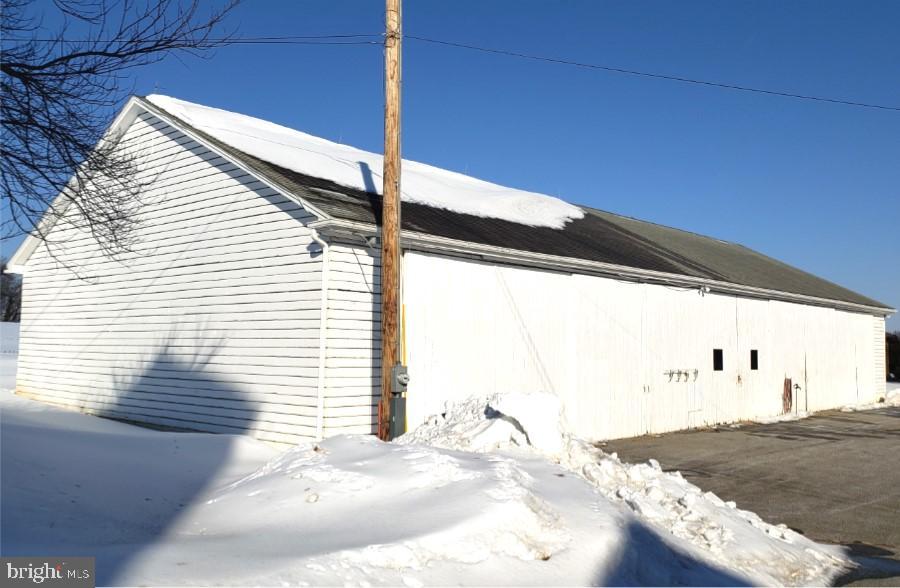 174 Fernwood Road Cochranville, PA 19330 - Photo 14 of 22 Snow-covered barn under a clear blue sky.