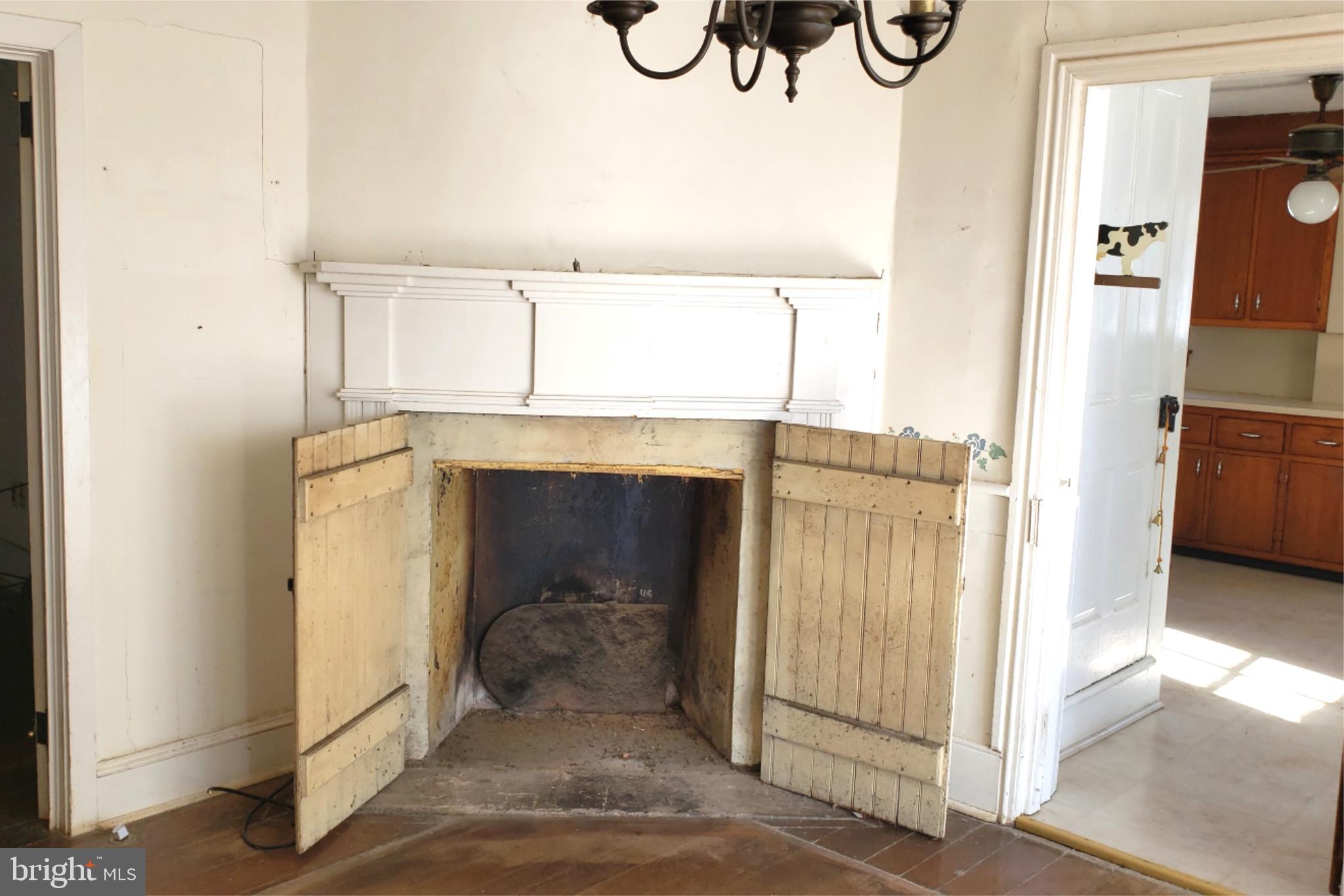 174 Fernwood Road Cochranville, PA 19330 - Photo 8 of 22 Charming vintage fireplace with rustic doors.