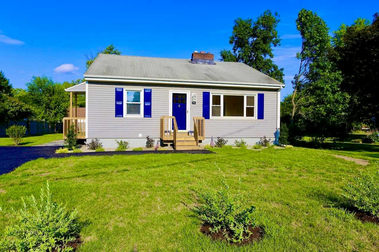 a front view of house with yard and green space
