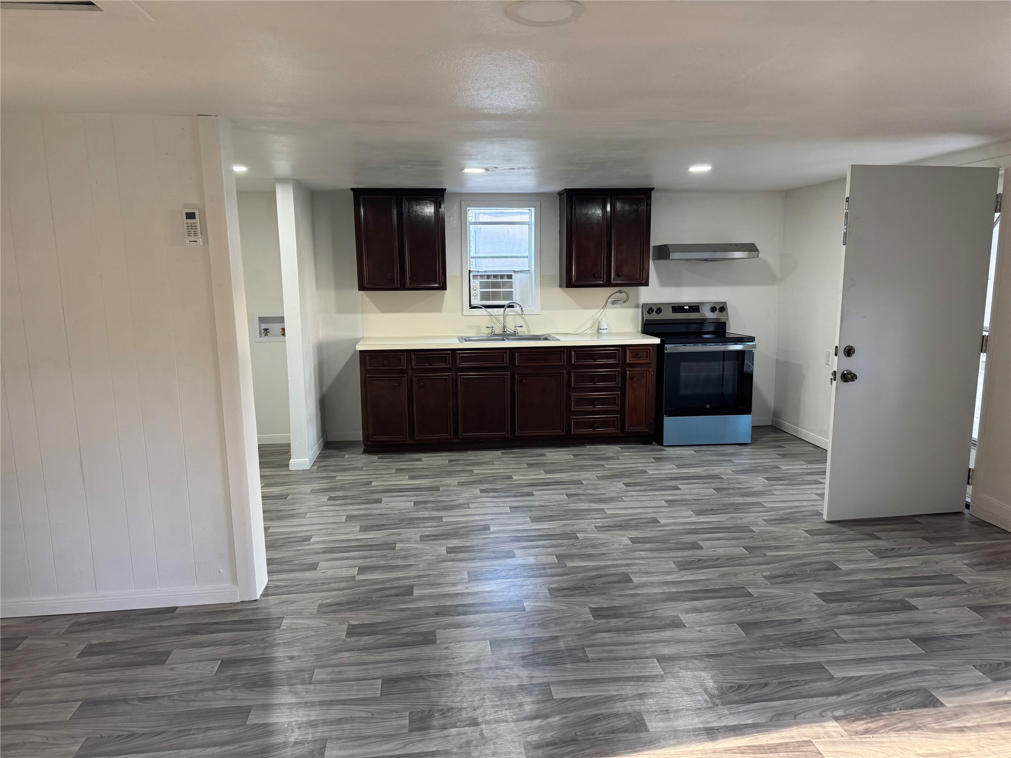 406 7th Street Alvin, TX 77511 - Photo 9 of 14 a kitchen with stainless steel appliances kitchen island granite countertop a refrigerator and a stove top oven