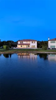 an aerial view of a house with a lake view