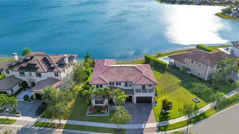 an aerial view of a house with outdoor space and lake view