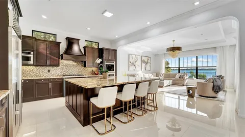 a kitchen with stainless steel appliances granite countertop sink stove top oven and cabinets