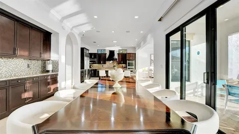 a bedroom with a large bed and a chandelier