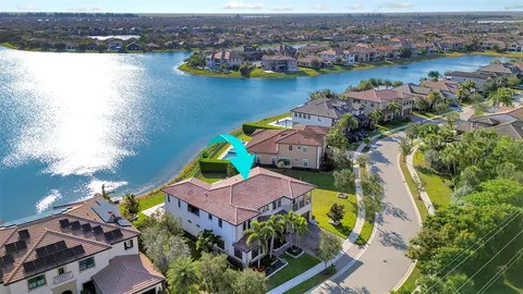 an aerial view of residential houses with outdoor space and lake view