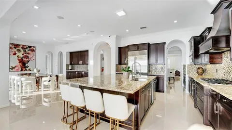 a bathroom with a granite countertop sink a light fixture and a mirror