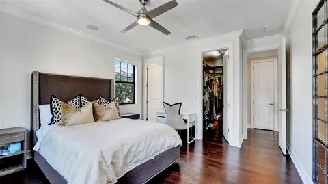 a view of a hallway with wooden floor and dining room view