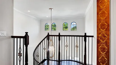 a spacious bedroom with a bed and a chandelier