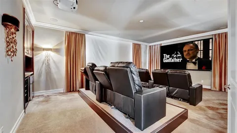 a view of a white house with a big yard and potted plants