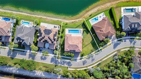 an aerial view of a house with a garden and swimming pool
