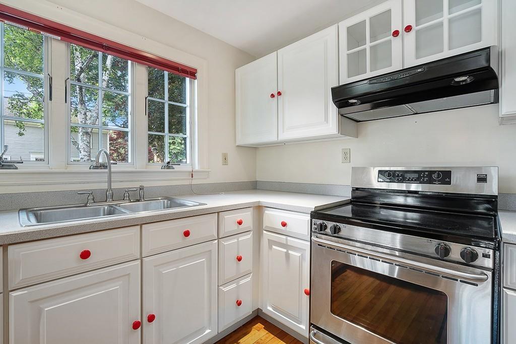 79 Pleasant Street Manchester, MA 01944 - Photo 12 of 28 a kitchen with white cabinets appliances and a sink
