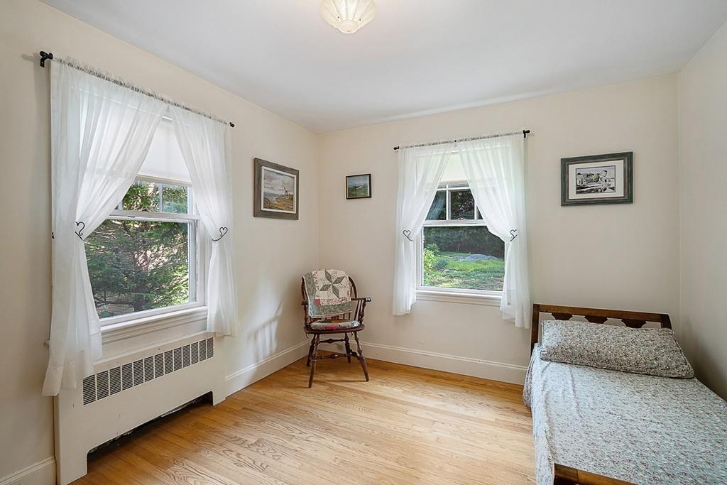 79 Pleasant Street Manchester, MA 01944 - Photo 15 of 28 a bedroom with furniture and a window