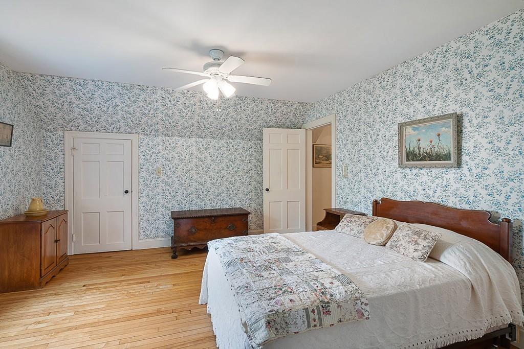 79 Pleasant Street Manchester, MA 01944 - Photo 22 of 28 a bedroom with a bed and wooden floor