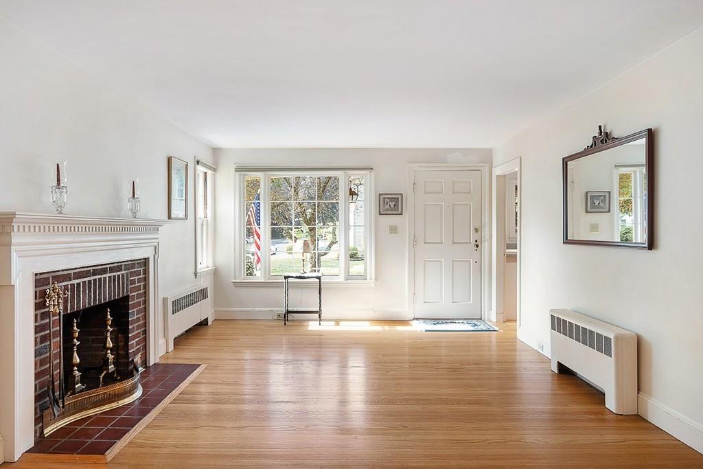 79 Pleasant Street Manchester, MA 01944 - Photo 4 of 28 a view of an empty room with a fireplace and a window