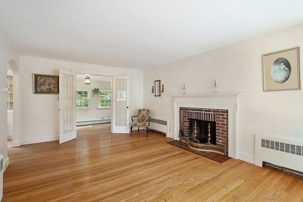 79 Pleasant Street Manchester, MA 01944 - Photo 5 of 28 a view of a livingroom with wooden floor and a fireplace