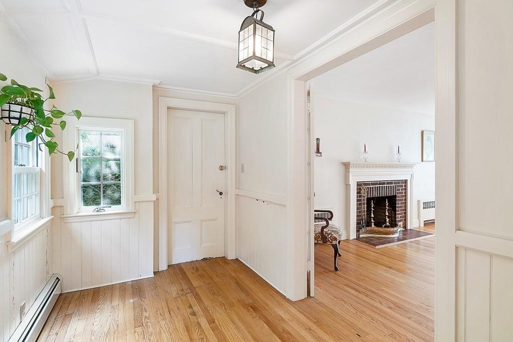 79 Pleasant Street Manchester, MA 01944 - Photo 9 of 28 a view of a livingroom with wooden floor fireplace and window