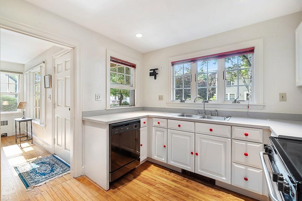 79 Pleasant Street Manchester, MA 01944 - Photo 10 of 28 a kitchen with granite countertop a stove and white cabinets