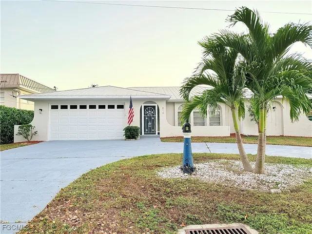 a house with palm tree in front of it