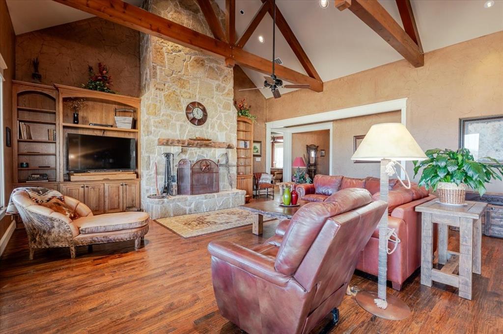11918 Riek Road Krum, TX 76249 - Photo 11 of 40 a living room with furniture and a flat screen tv