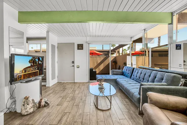 a living room with furniture and a wooden floor