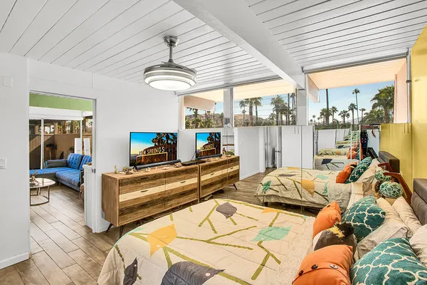 a bedroom with furniture and a large window
