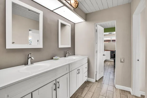 a bathroom with a double vanity sink and mirror