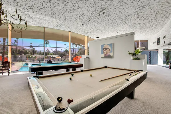 a living room with furniture and a floor to ceiling window
