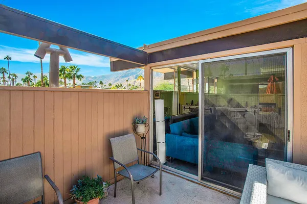 a porch with a table and chairs