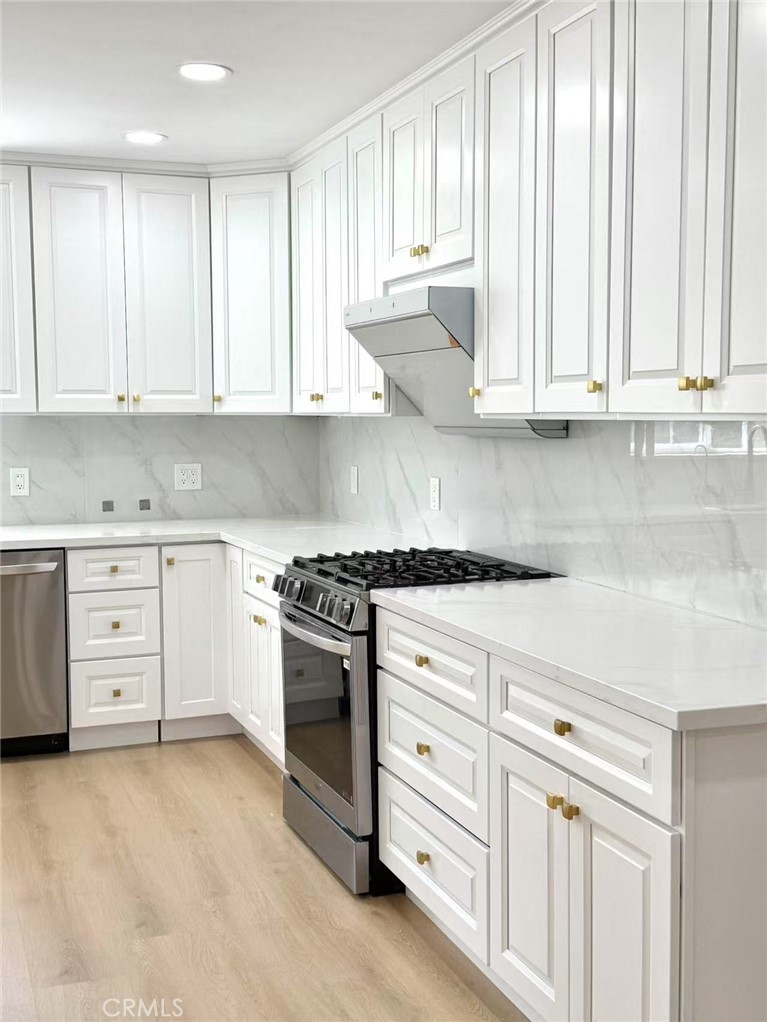 1500 Loganrita Avenue Arcadia, CA 91006 - Photo 5 of 29 a kitchen with granite countertop white cabinets and stainless steel appliances