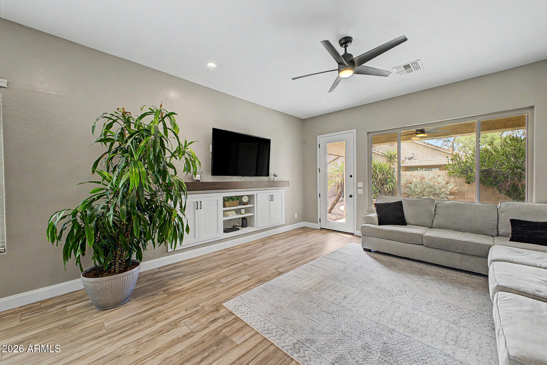 4272 East Buckboard Road Gilbert, AZ 85297 - Photo 13 of 37 a living room with furniture a flat screen tv and a large window