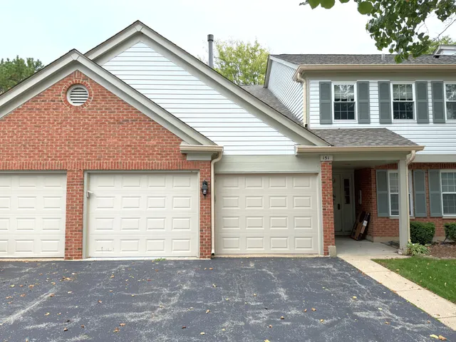 a view of a house with a yard and garage