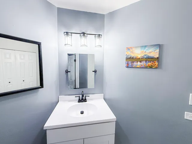 a bathroom with a sink and a mirror