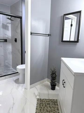 a bathroom with a sink toilet and shower
