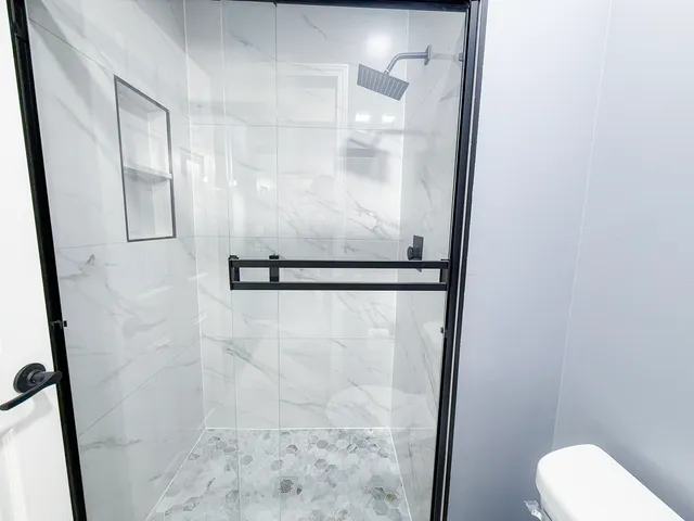 a bathroom with a shower and toilet