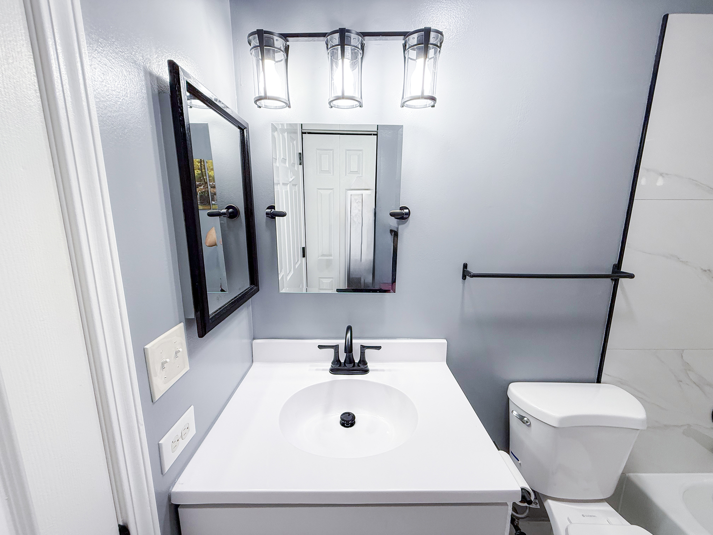 151 Brookston Drive, Unit A2 Schaumburg, IL 60193 - Photo 8 of 18 a bathroom with a sink a toilet and mirror