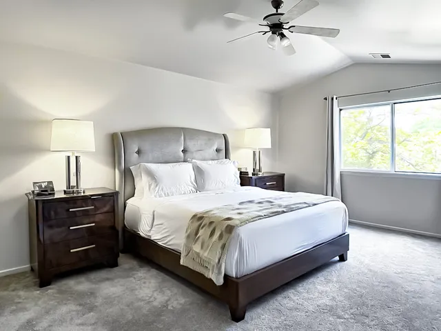 a bedroom with a bed and window