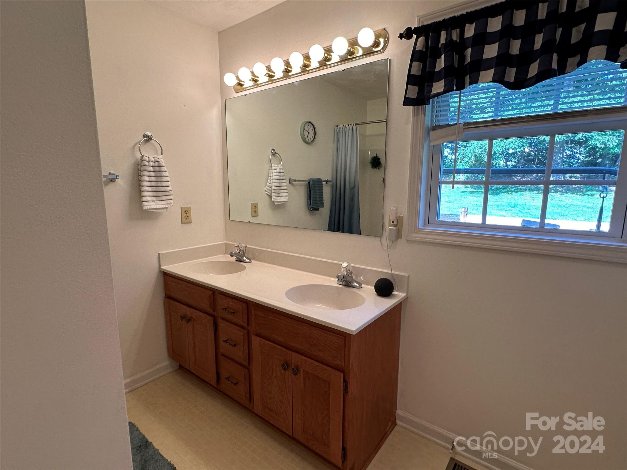 4886 Sandstone Drive Conover, NC 28613 - Photo 13 of 22 a bathroom with a double vanity sink and a mirror