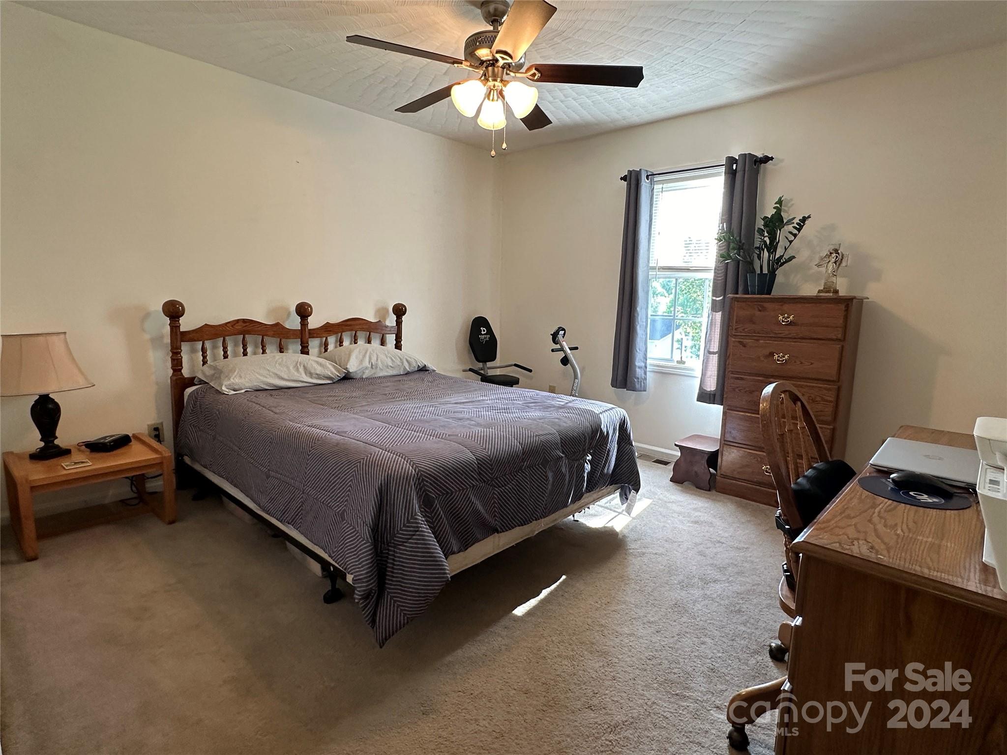 4886 Sandstone Drive Conover, NC 28613 - Photo 14 of 22 a bedroom with a bed and a chandelier