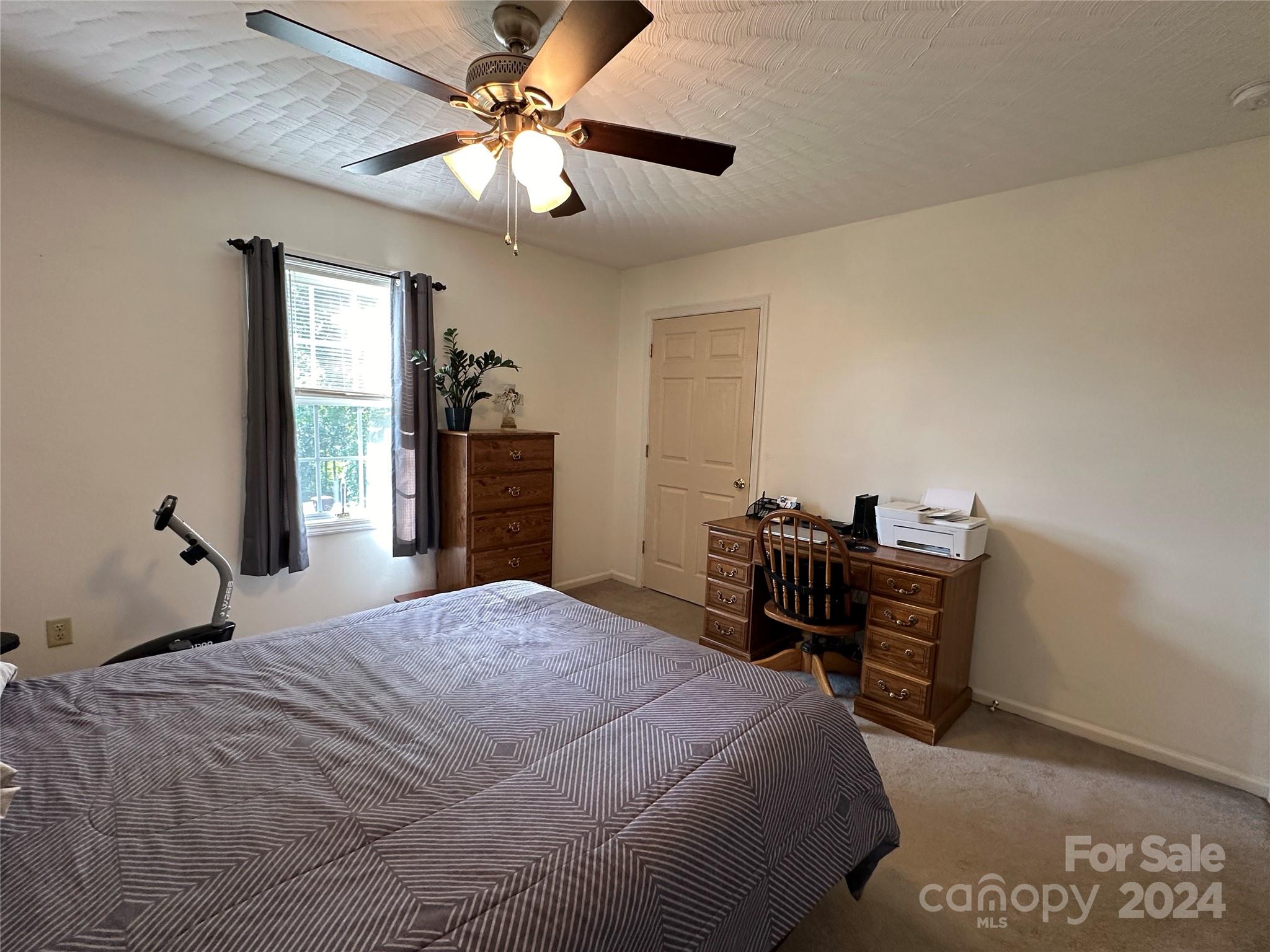 4886 Sandstone Drive Conover, NC 28613 - Photo 15 of 22 a bedroom with a bed and a chandelier