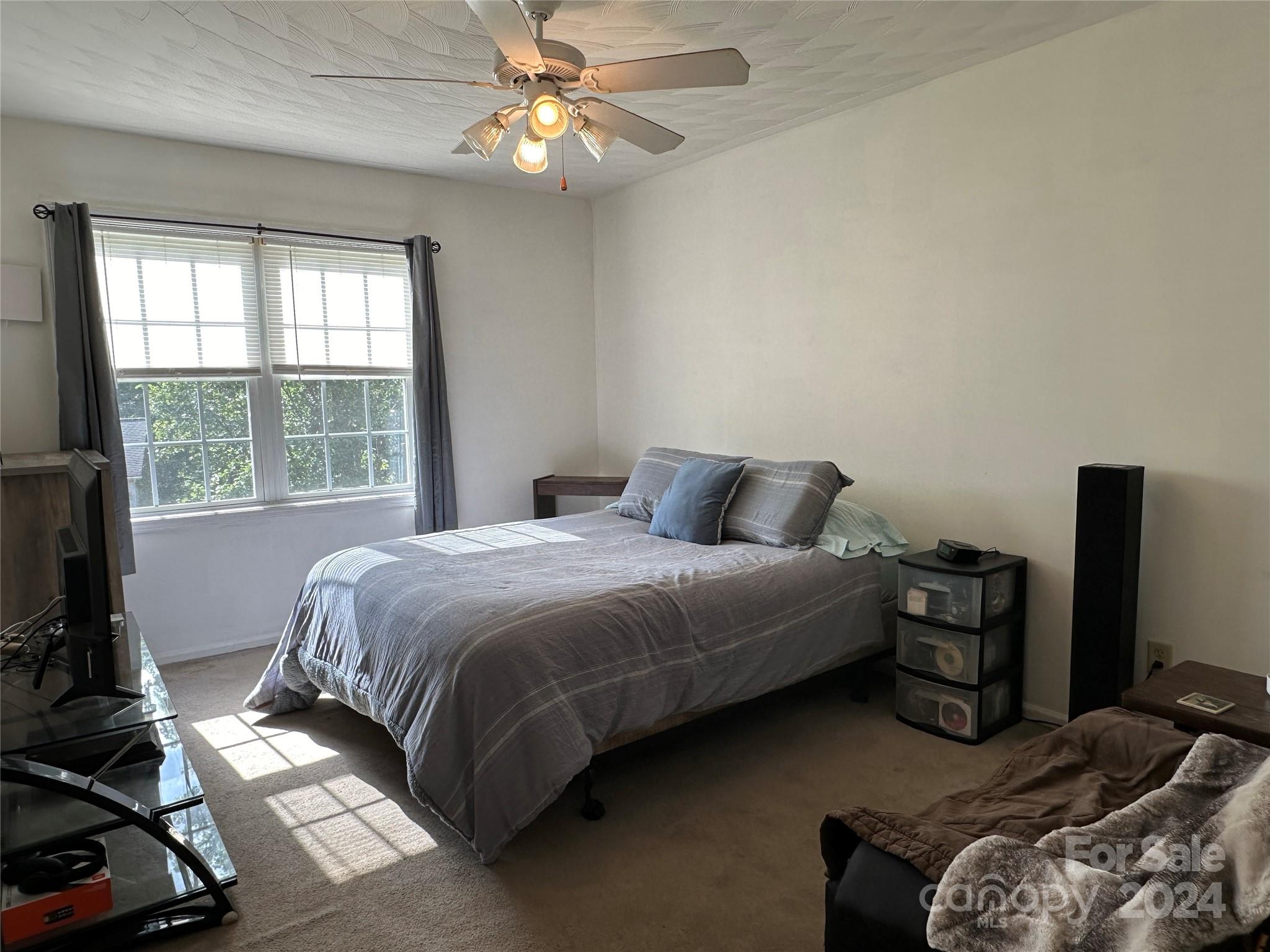 4886 Sandstone Drive Conover, NC 28613 - Photo 16 of 22 a bedroom with a bed and a chandelier